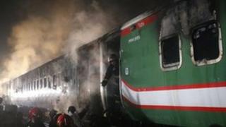 Firefighters are trying to extinguish a fire after arsonists set a Benapole Express train ablaze in Dhaka, Bangladesh
