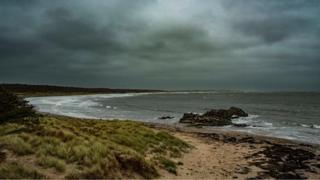 Cloudy skies over a beach