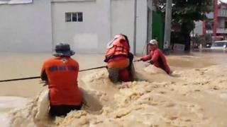 Person being rescued in flood water