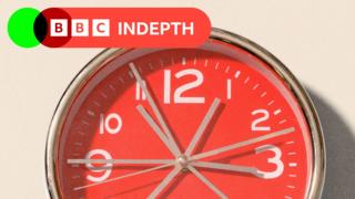 A red clock showing grey whirring hands, on the upper left there is a red logo which reads BBC InDepth in white lettering
