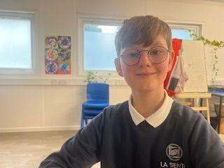 Boy in uniform in a classroom