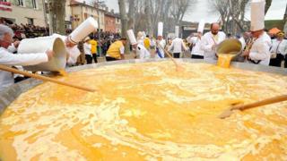 Members of the Giant Omelette Brotherhood of Bessieres cook a giant omelette as part of Easter celebrations.
