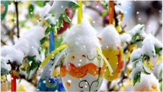 Decorative Easter eggs covered in snow