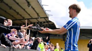 David Watson hands his boots to a Killie fan after a 4-1 win at Livingston on the final day of the SPL season last month.