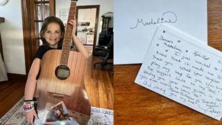 Young fan holds signed guitar + letter to fan from Taylor Swift