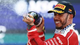 Ferrari's Lewis Hamilton sprays champagne on the podium after winning the Barcelona-Catalunya Grand Prix