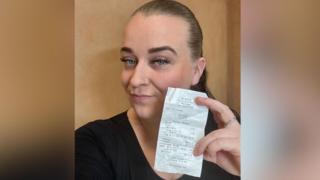 Sophie Downing holding a receipt