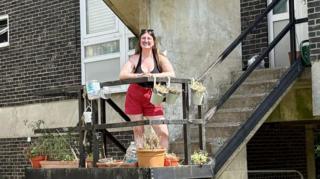 Katrina outside a 1960s style residential block