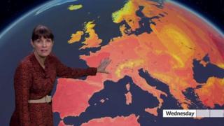 Susan Powell stands in front of a weather map of Europe