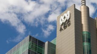 ABC Australia's building and logo against a blue sky background with some white clouds