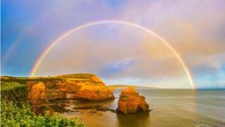 Double rainbow appearing over the sea