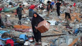 Palestinians in Gaza retrieve belongings after Israeli air strike