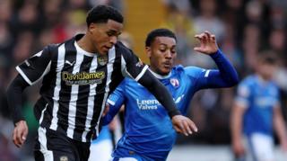 Tom Iorpenda of Notts County runs with the ball while under pressure from Lewis Gordon of Chesterfield