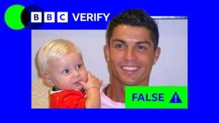 A digitally-altered image purporting to show a young Cristiano Ronaldo holding Erling Haaland as a baby. There is blue and green BBC Verify branding around the image.