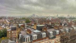 Dark clouds over a London skyline.