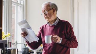 An old man worried over bills 