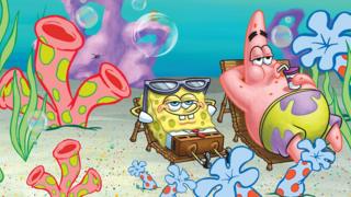 Spongebob and Patrick sitting on deck chairs with sunglasses on.