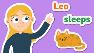 A girl pointing at the words 'Leo sleeps' above a sleeping cat.
