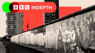A treated image showing the Berlin Wall with housing blocks on the other side, and the Berlin Television Tower in the distance