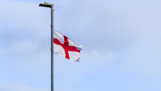 A St George's flag flies from a lamp post
