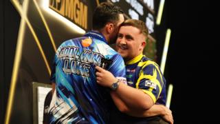 Luke Littler (right) embraces Luke Humphries after victory in the final on night thirteen of the BetMGM Premier League 2026 at P&J Live, Aberdeen.