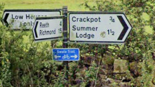 Street signs that point in various directions, with the text "Crackpot" displayed "Summer Lodge". 