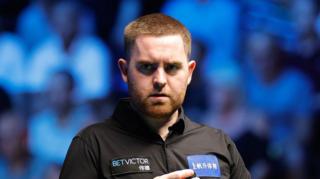 Jak Jones chalks his cue