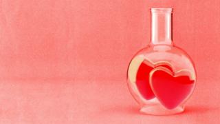 A treated image of a glass beaker with two hearts inside