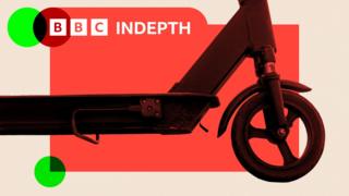 A montage image shows the front wheel and footboard of a dark-coloured e-scooter, viewed from the side. In the background is a red backdrop with a beige frame. The BBC InDepth logo is in the top left-hand corner and a green dot is in the bottom left.