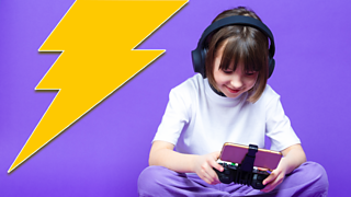 Young girl on a gaming device with headphones on.