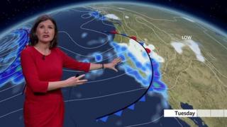 Helen Willetts stands in front of a weather map of the Pacific west coast of the US