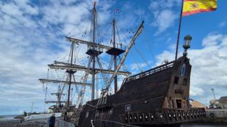 The Galeón Andalucía, a large 17th century Spanish galleon, berthed in port at Ayr harbour. A Spanish flag flies from the rear of the ship.