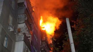 Buildings burn as another wave of Russian attacks hits Ukraine