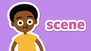 A boy smiling next to the word 'scene'