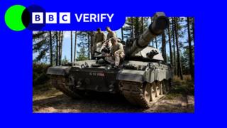 Three soldiers sitting on top of a tank. The BBC Verify logo appears in the top left corner.