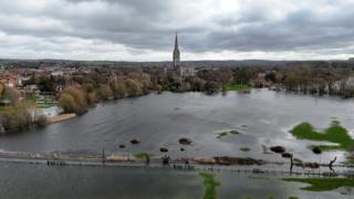 Aerial view of Salisbury showing extensive flooding in the foreground and Salisbury Cathedral in the background