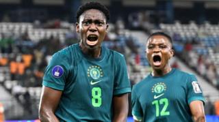 Asisat Oshoala and Uchenna Kanu celebrate a goal for Nigeria