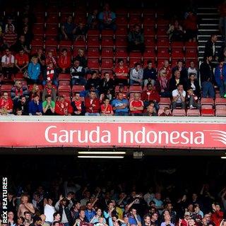 West Ham fans celebrate during their win at Anfield in September, with empty seats above them