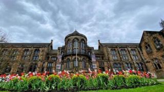 Cloudy skies behind a building in Glasgow.