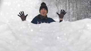 鶹ҳ Weather's Matt Taylor standing in a pretend snow drift