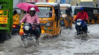 Vehicles drive through flooded streets in Chennai