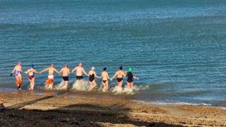 Swimmers running into the sea on New Year's Day in Kent