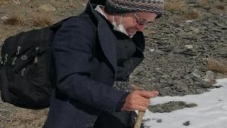Kameel Ahmady walks through mountains while escaping Iran