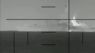 Alternative description
A black and white image of an Iranian warship through a scope