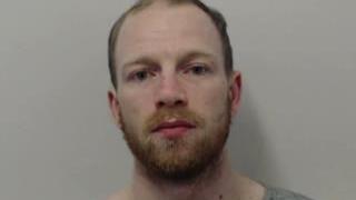 Mugshot of Jordan Honeyman. He was short brown hair and a beard and moustache