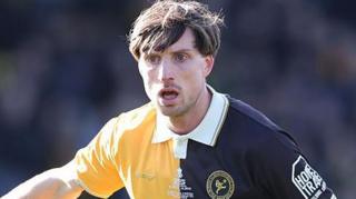 Bradford City player Jake Beesley pictured in the yellow and black kit of former club Burton Albion