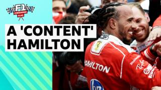 Lewis Hamilton smiling in Ferrari race suit