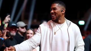 British boxer Anthony Joshua shakes hands at the fight between Deontay Wilder and Derek Chisora
