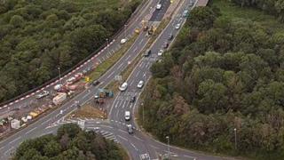 Aerial view of roadworks on an A road, with some cars on it