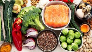 Various brain food products: fish, meat, nuts, vegetables and greens. Healthy food on a light background. Top view.